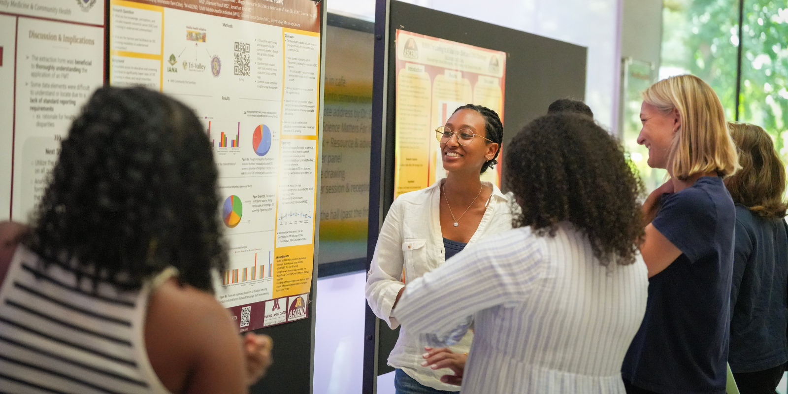 Group of women talking at scientific poster