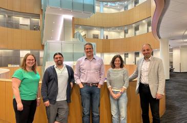 The MCC-Mayo partnership team poses in the atrium at the Cancer and Cardiovascular Research Building, one of MCC's research buildings.