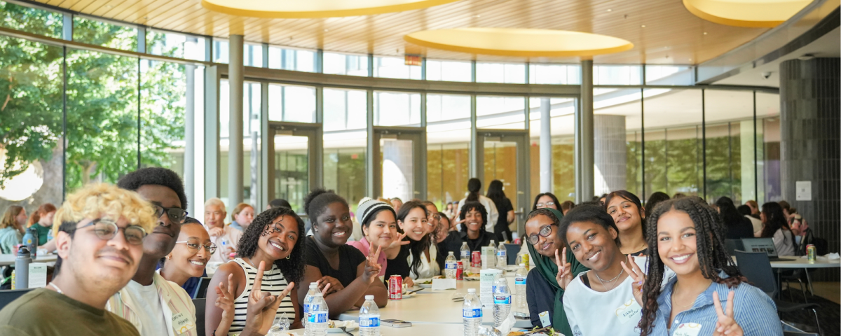 Group of students eating lunch together at event